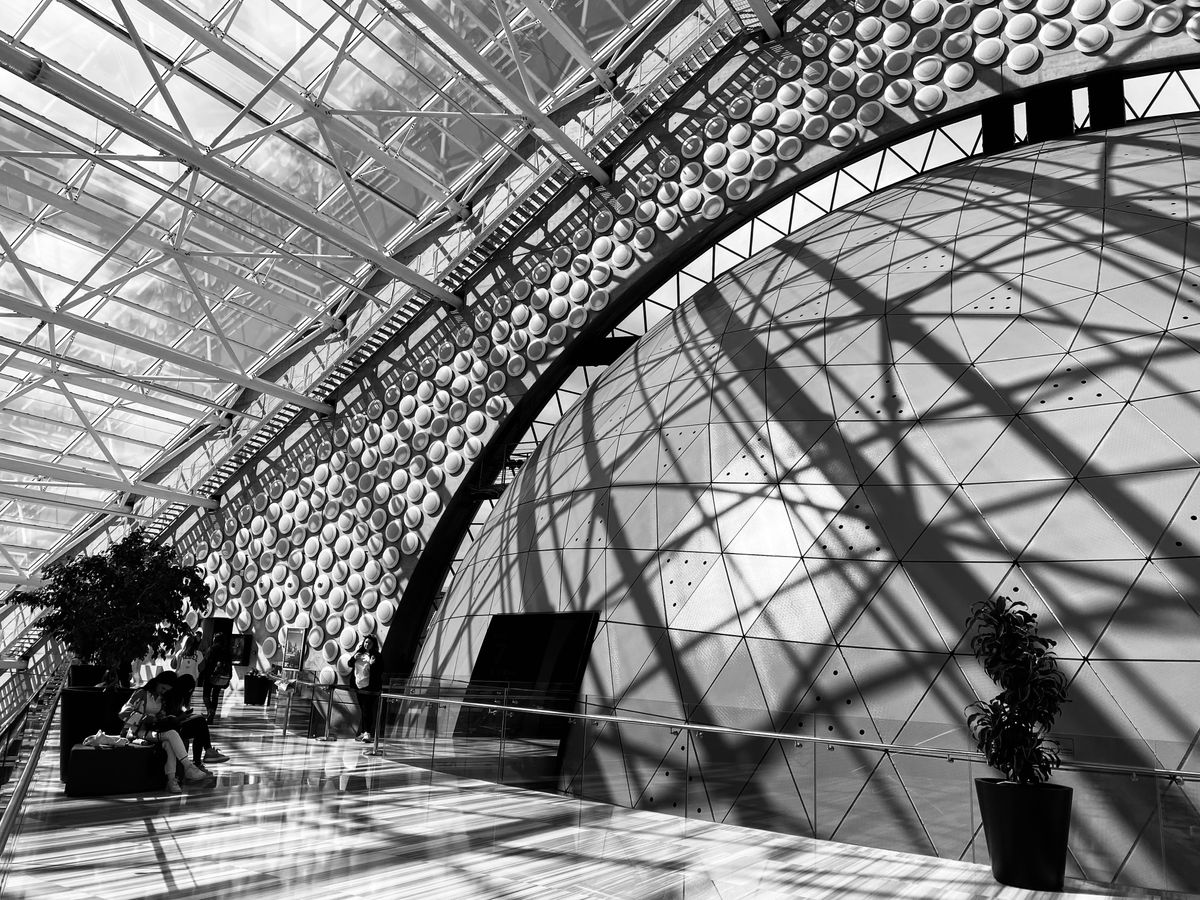 a black and white photo of people sitting on benches